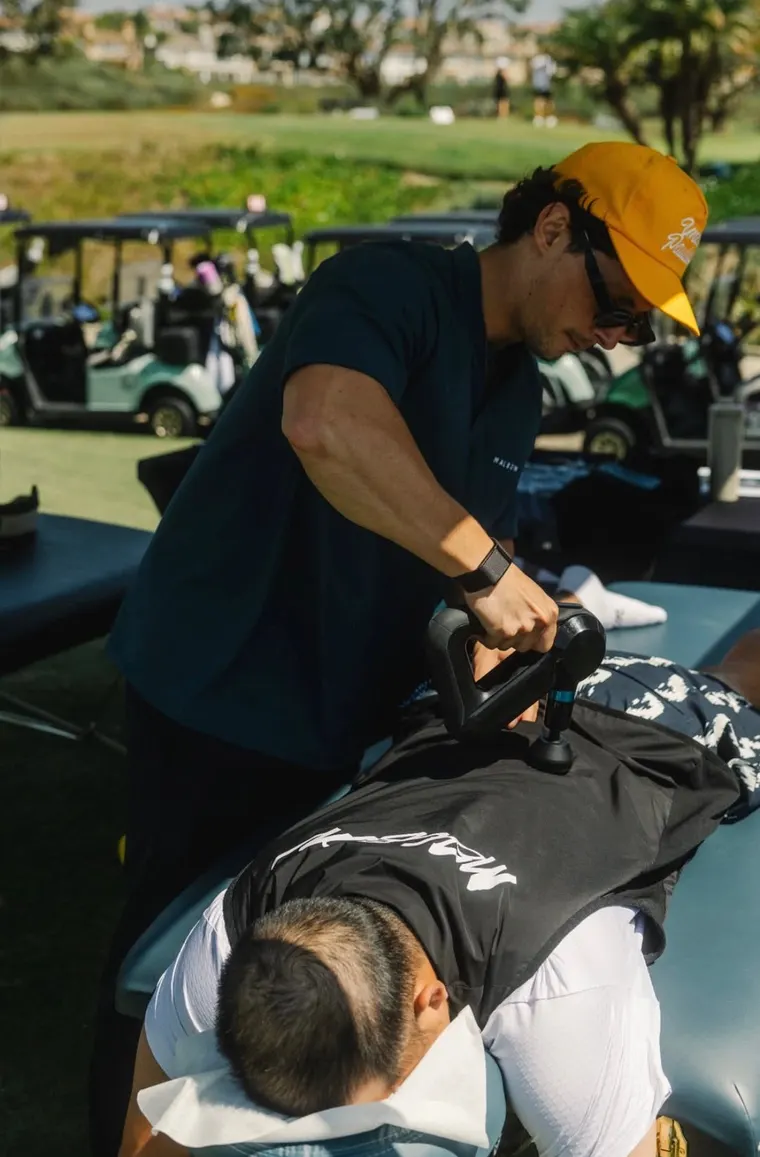Dr. Eddie Uluchyan treating a client on-site at a golf event